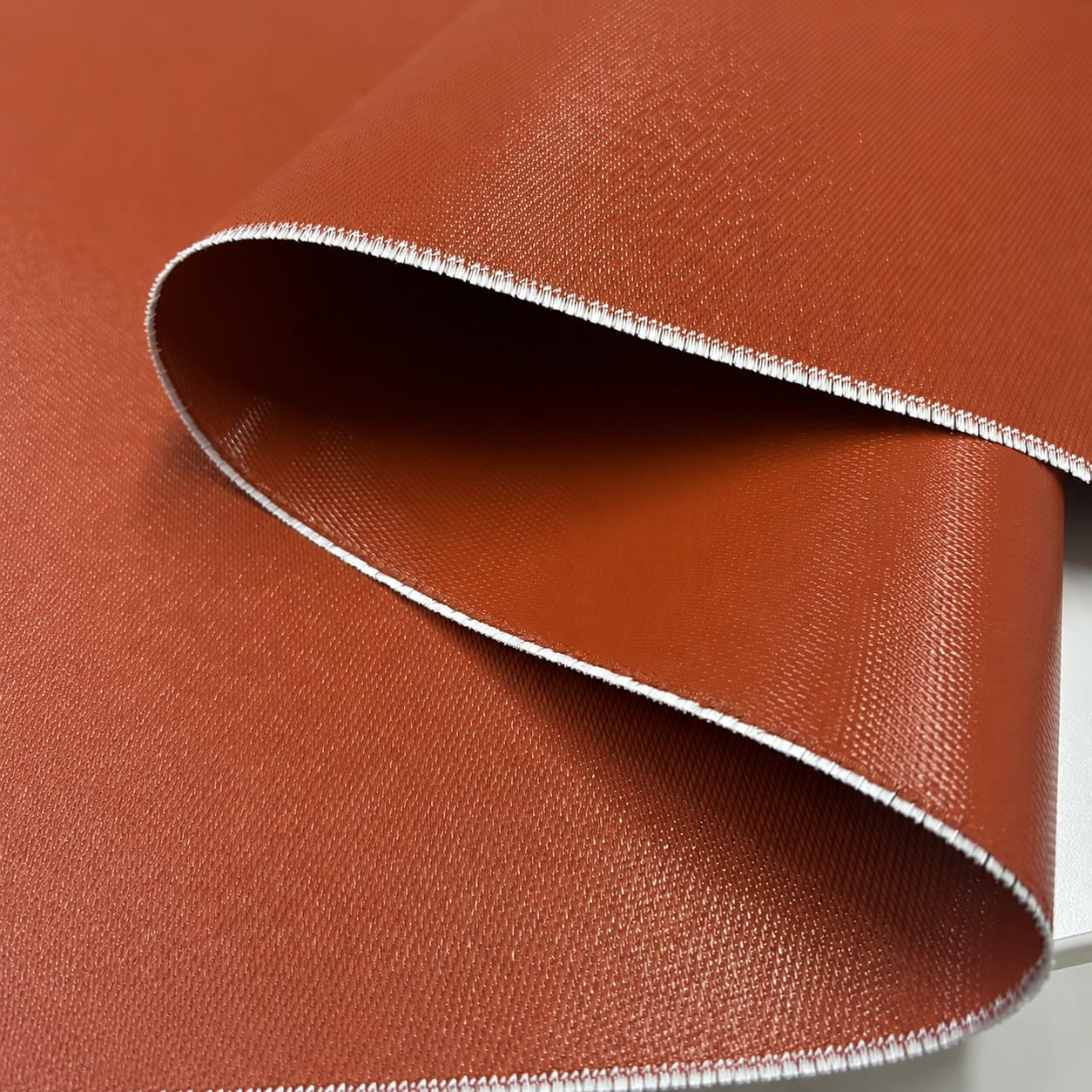 0.76mm 985gsm iron red double-sided silicone coated fiberglass fabric roll with cut edge view