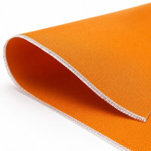 Close-up of orange silicone coated fiberglass fabric roll edge showing woven fiberglass structure and coating